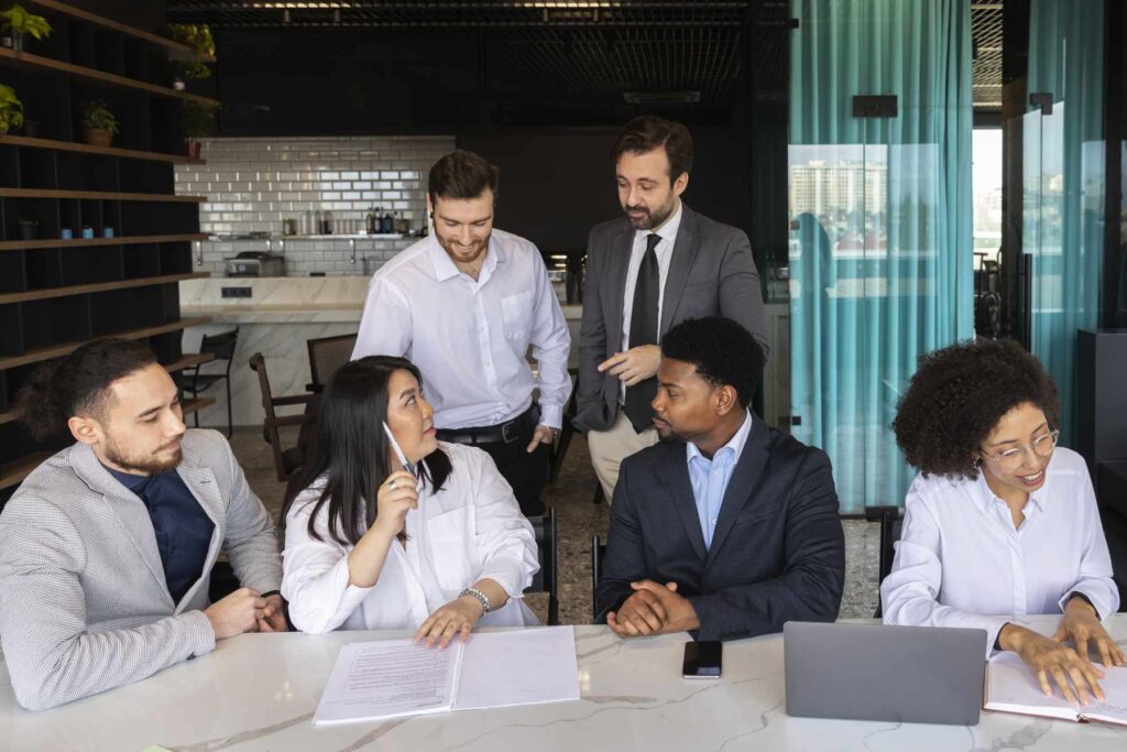 Pessoas participam de uma reunião corporativa ao redor de uma mesa