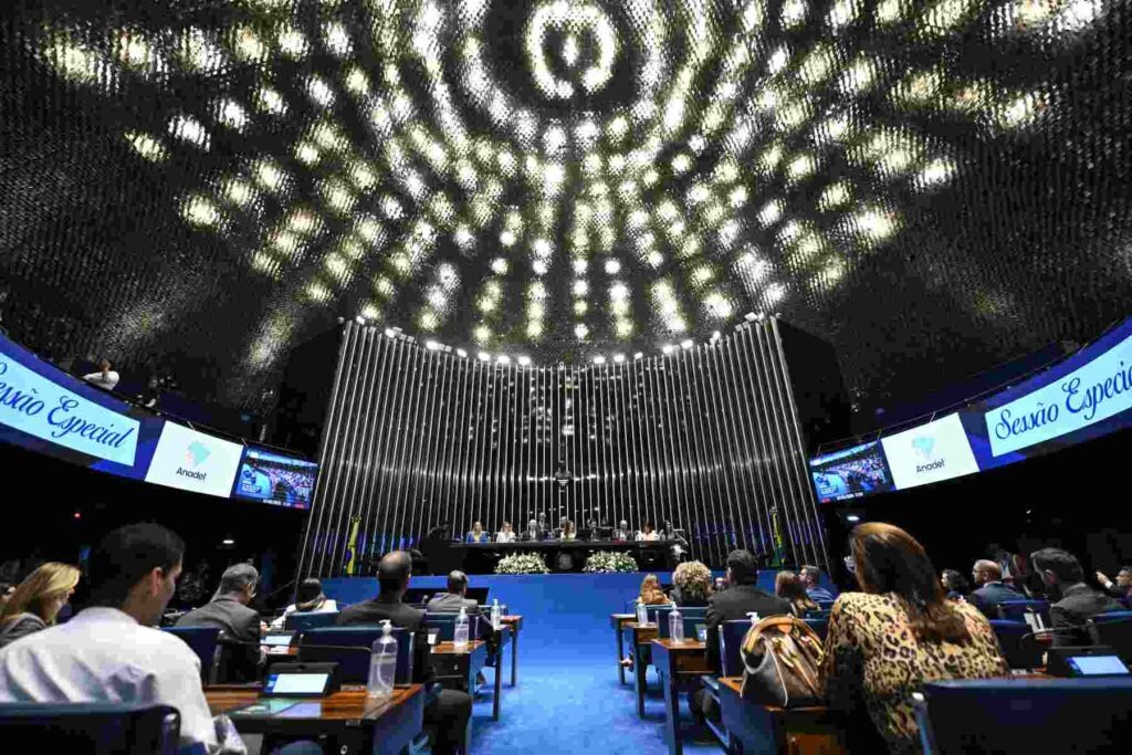Vista interna do plenário do Senado Federal, focando nas luzes do teto, durante sessão especial de homenagem